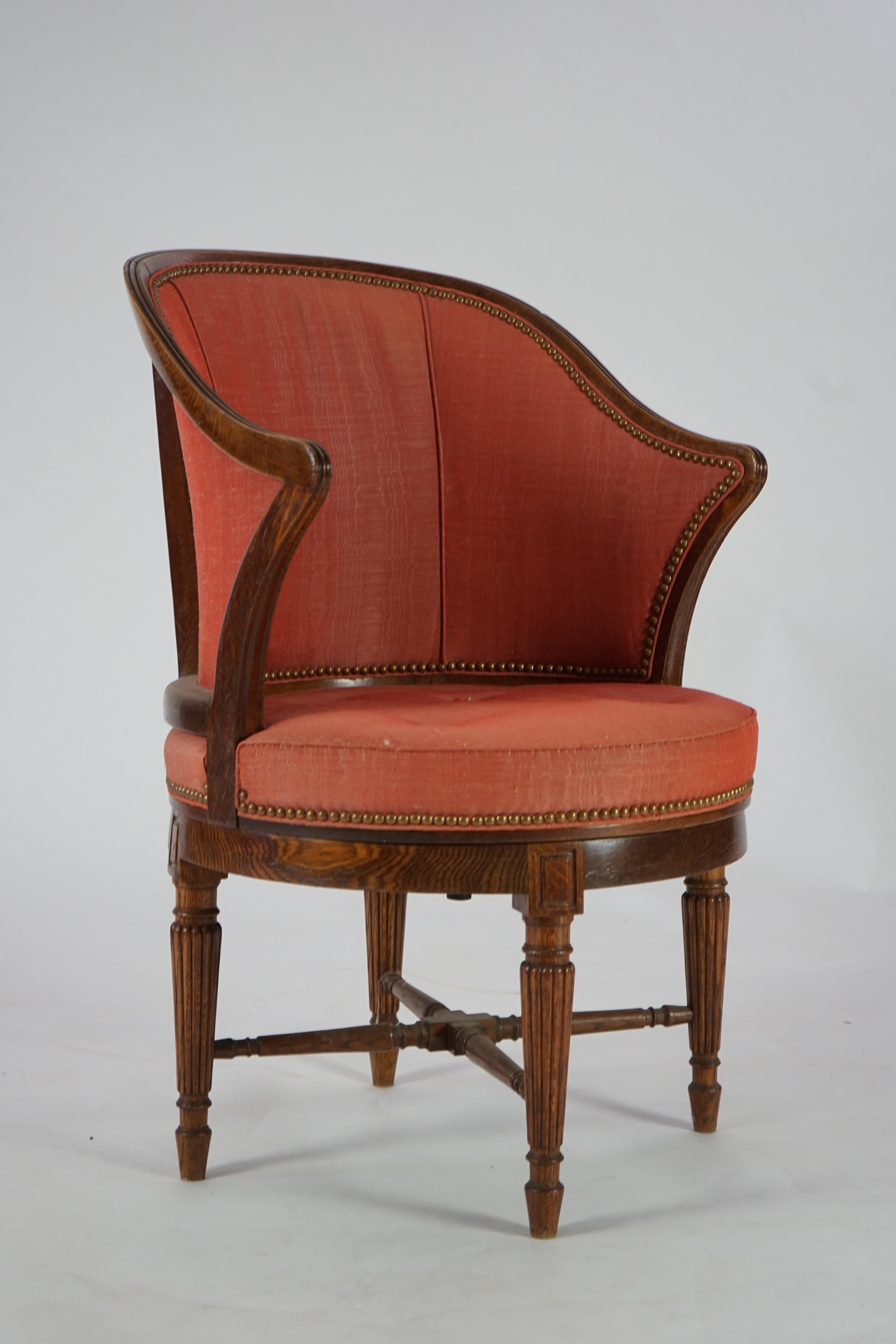 An unusual late Victorian oak revolving desk chair by Waring & Sons